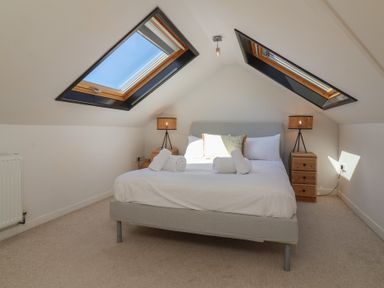 A bedroom with a bed and bedside lamps at Auverne Poundstock near Widemouth Bay