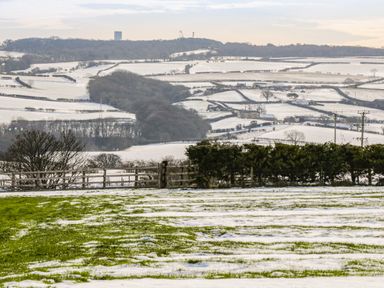 A snow-covered rural landscape with fields trees and fences at Shipswheel Cottage at Broadings Farm in Whitby