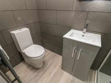 A bathroom with a toilet and a sink cabinet at Box Tree Escapes in Wennington near Kirkby Lonsdale
