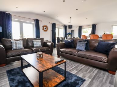 A living room with two brown leather sofas and a wooden coffee table at Box Tree Escapes in Wennington near Kirkby Lonsdale
