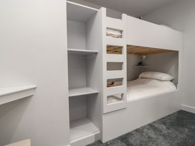 A bedroom with a built in bunk bed and shelves at Box Tree Escapes Wennington near Kirkby Lonsdale