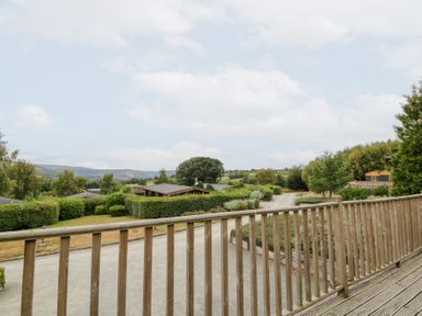 A view from a wooden deck overlooking a garden at Mountain View in Rhayader