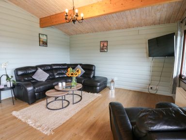 A living room with a sofa and coffee table at Mountain View in Rhayader