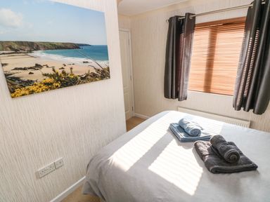 A bedroom with a bed covered in towels and a window with blinds and curtains at Jules @ 79 in Stepaside