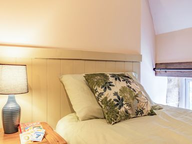 A bedroom with a bed side table lamp and uno cards at Meadowsweet in Goathland