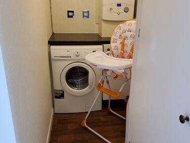 A laundry room with a washing machine highchair and boiler at Lodge 11 in Tavistock