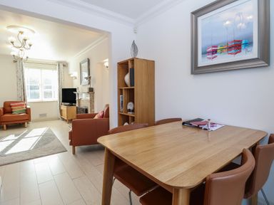 A dining area with a table and chairs at 5 Styleman Road in Hunstanton