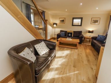 A living room with sofas and a coffee table at Low Croft in Embleton