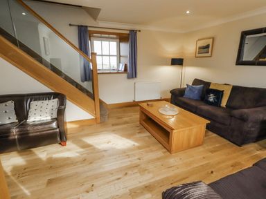 A living room with sofas and a coffee table at Low Croft in Embleton