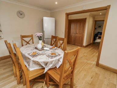 A dining room with a table and chairs at Low Croft in Embleton