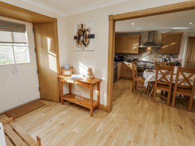 A kitchen area with wooden table and chairs at Low Croft in Embleton