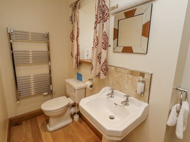 A bathroom with a toilet and sink at Low Croft in Embleton