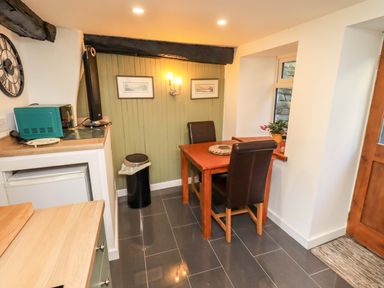 A dining room with a table and chairs at Buttonhole Cottage in Ambleside