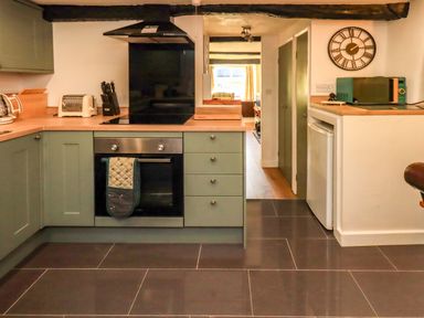 A kitchen with appliances and counter space at Buttonhole Cottage Ambleside