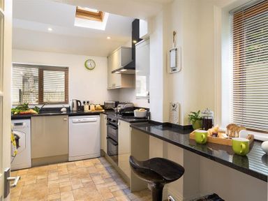 A kitchen with appliances on countertops including a kettle and toaster at Hill Cottage in Ambleside