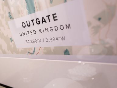 A close-up of a framed map showing Outgate United Kingdom with coordinates 54.390Â°N 2.994Â°W at Barn End Ambleside