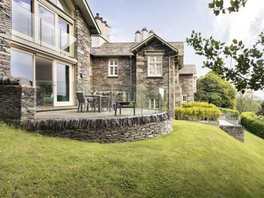 A house with a deck and dining area at Take Five in Ambleside