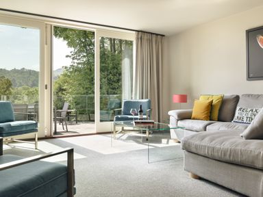 A living room with a sofa and armchairs at Take Five in Ambleside