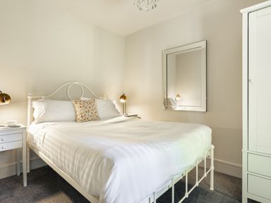 A bedroom with a bed and nightstand at Take Five in Ambleside