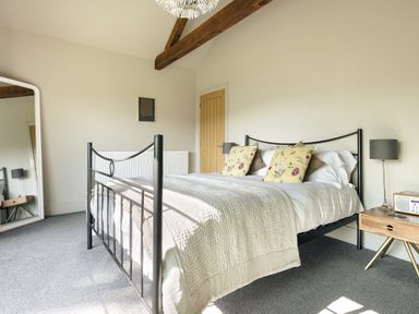 A bedroom with a bed and mirror at Take Five in Ambleside