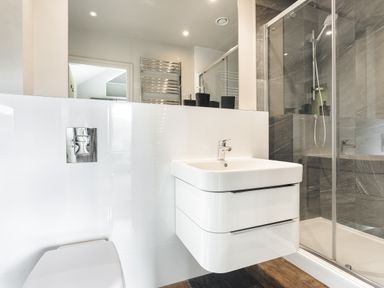 A bathroom with a sink, toilet, shower, and towel radiator at Take Five in Ambleside
