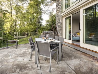An outdoor dining area with a table and chairs at Take Five in Ambleside