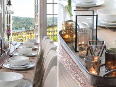 A dining table set with white bowls plates wine glasses and candles in holders at Hawkrigg Farm in Hawkshead