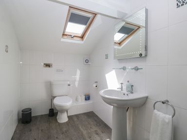 A bathroom with toilet and sink at Woodside West in Bowness