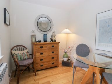 A dining room with a table and chairs at Corner Cottage in Troutbeck