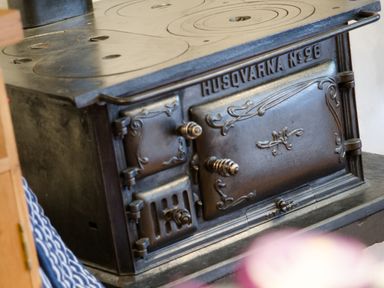 A close up of a vintage Husqvarna No 96 cast iron stove