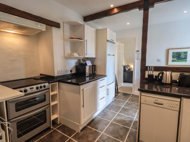 A kitchen with appliances and cabinets at A River Runs By in Staveley