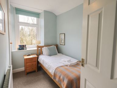 A bedroom with a bed and bedside table at A River Runs By in Staveley