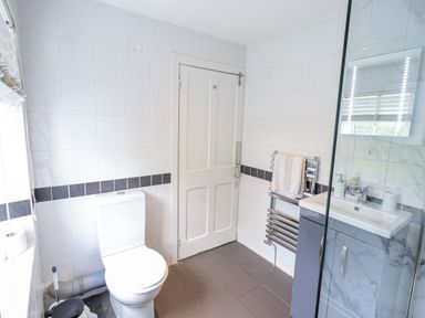 A bathroom with a toilet and sink at Smithy Cottage at Bowland Bridge Bowness