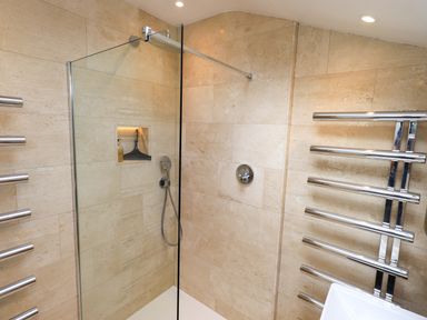 A shower area with glass door and fixtures at Beck Steps in Chapel Stile