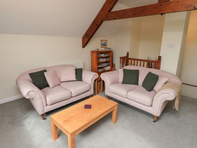 A seating area with two sofas and a wooden coffee table at The Old Chapel in Crook