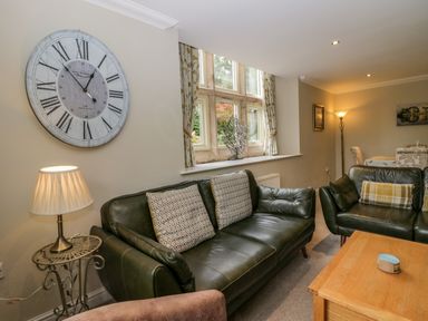 A living room with sofa and clock at Middlerigg in Troutbeck