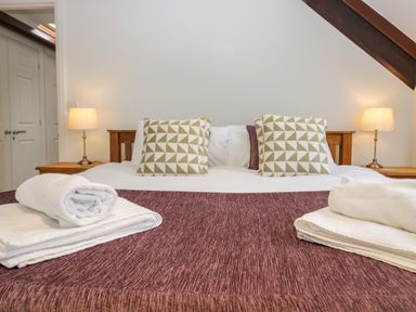 A bedroom with a bed and pillows at Middlerigg in Troutbeck