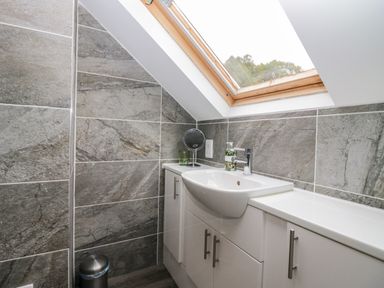 A bathroom with a sink and mirror at Middlerigg in Troutbeck
