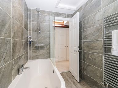 A bathroom with a bathtub and shower at Middlerigg in Troutbeck