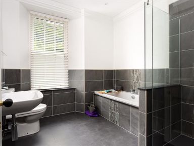 A bathroom with a toilet sink bathtub and shower at Ben House in Grasmere