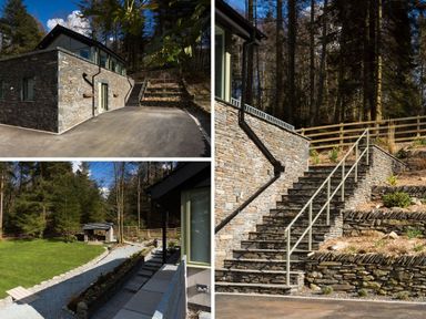 Stone house exterior with paved driveway and steps surrounded by trees and garden at Tall Trees in Bowness