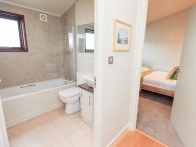 A bathroom with a bathtub and toilet at Thie Loghey in Hawkshead