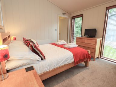 A bedroom with a bed and television at Thie Loghey in Hawkshead