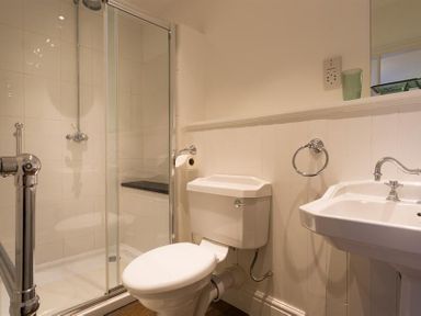 A bathroom with a shower, toilet, and sink at Orrest Range in Windermere