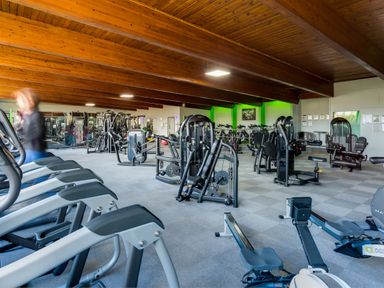An indoor gym with exercise machines and treadmills at Orrest Range in Windermere