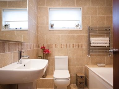 A bathroom with a sink toilet bathtub and towel rack at Mount Sol in Ambleside
