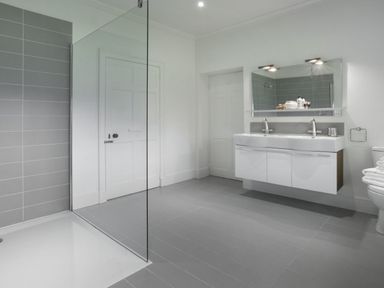 A bathroom with a double sink vanity mirror and toilet at Tent Lodge in Coniston