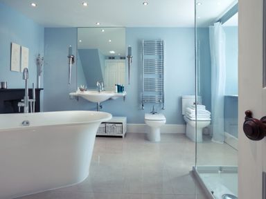 A bathroom with a bathtub, sink, bidet, toilet, shower, and towel rack at Tent Lodge in Coniston