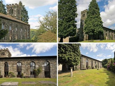 A stone church building with tall arched windows and a tower surrounded by trees and grass