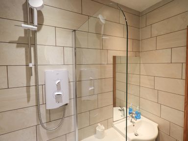 A bathroom with shower and sink at Boxwood Cottage in Troutbeck